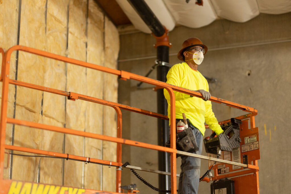 Technician in hard hat on construction site